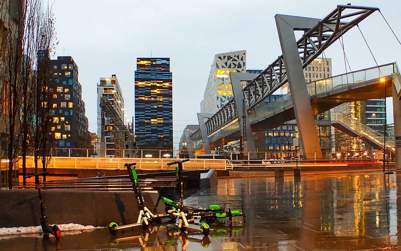 "Rain, reflections and a pile of scooters. Barcode. Oslo." by trine.syvertsen is licensed under CC BY 2.0.